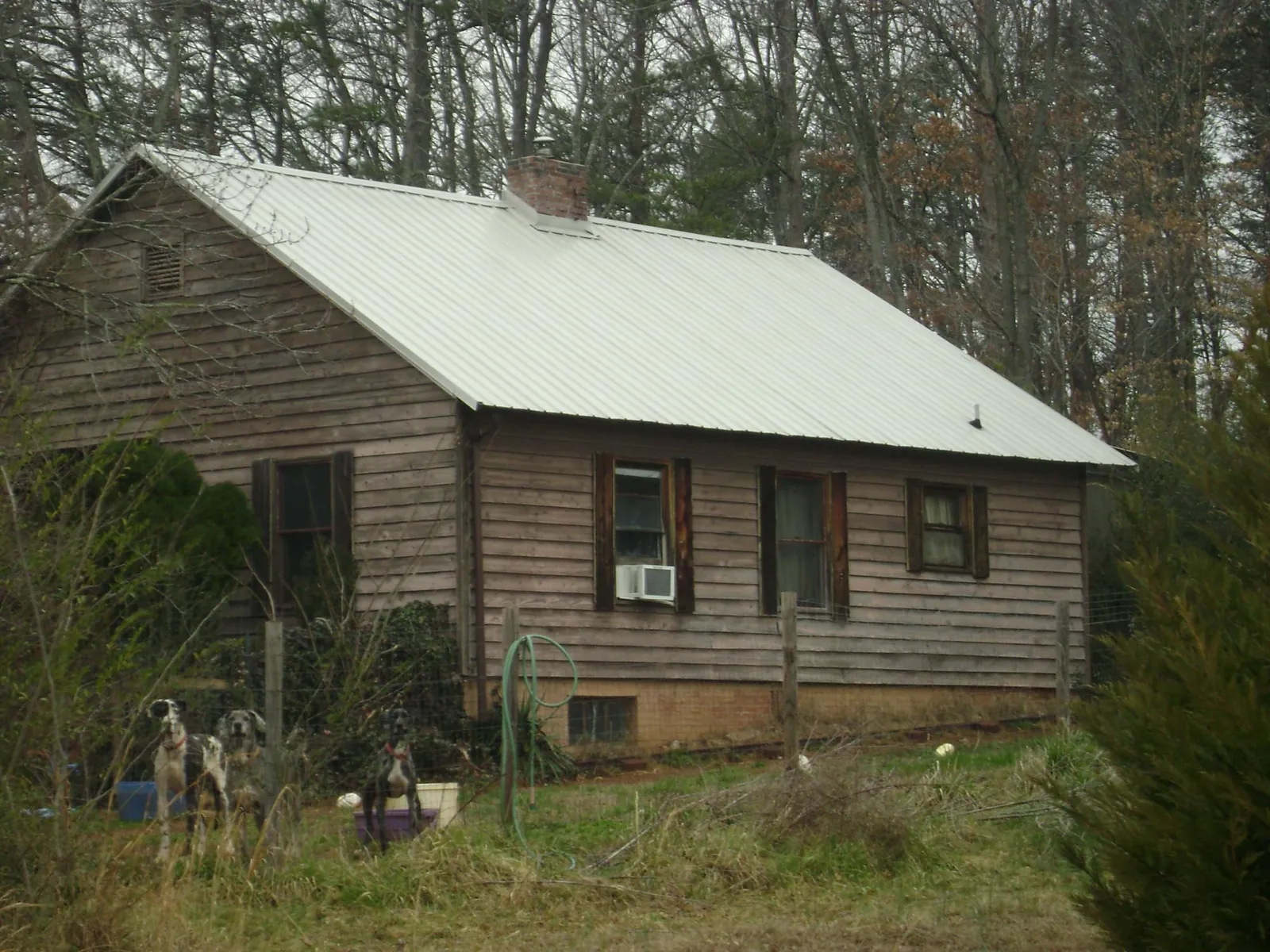White metal roof on an old wood sided farmhouse in Emporia